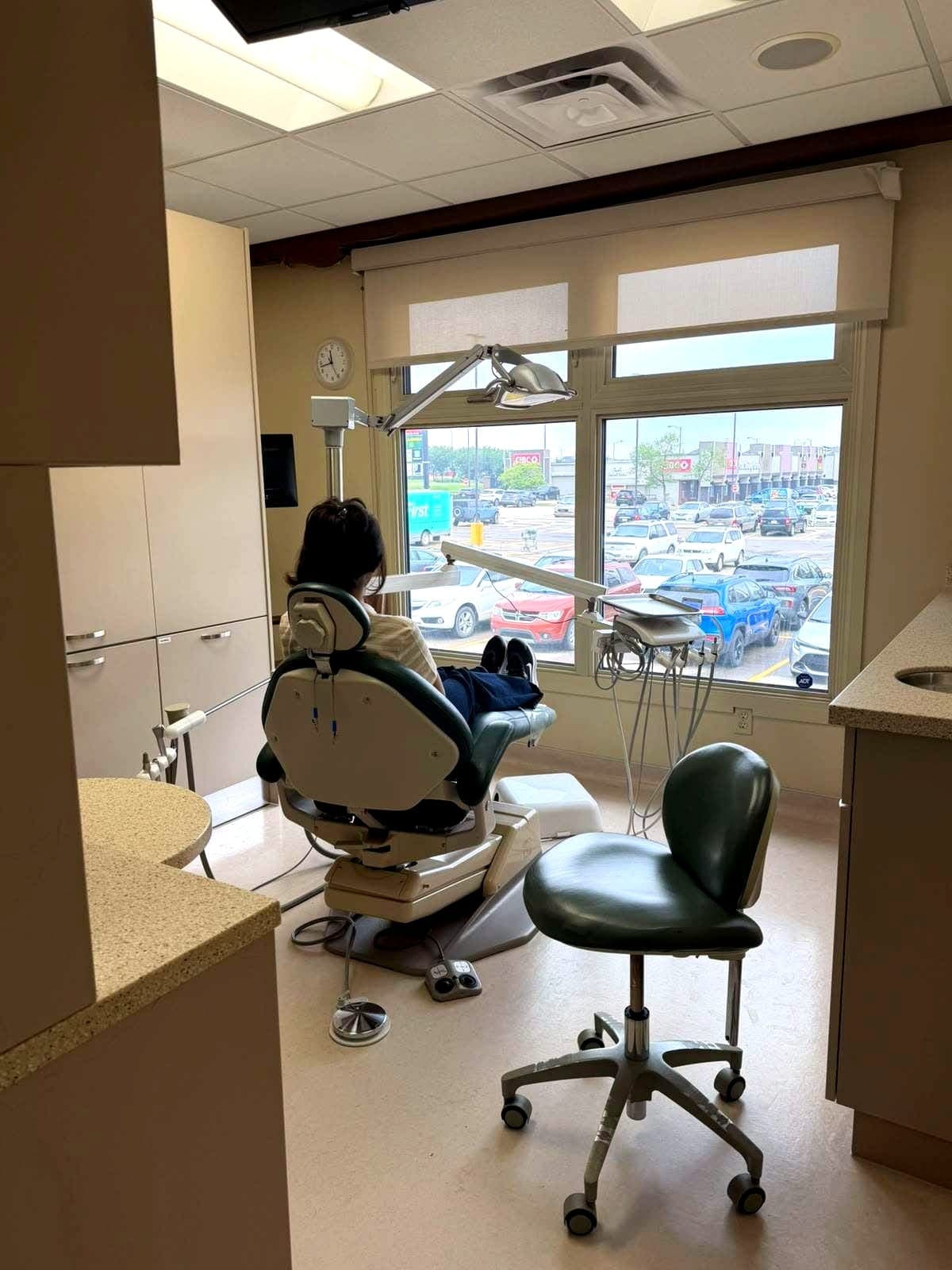 Dental operatory with patient chair overlooking the parking lot windows