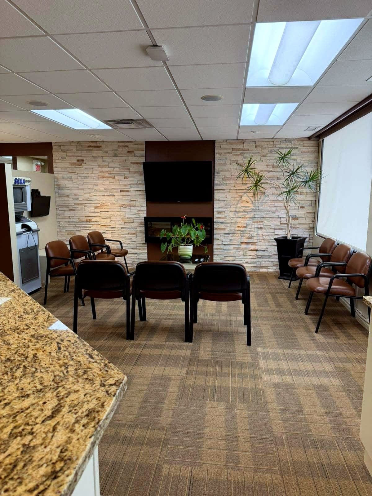 Comfortable waiting area with fireplace and stone feature wall